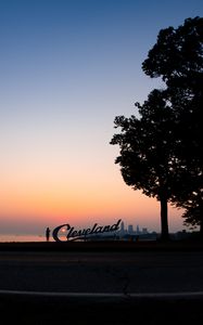 Preview wallpaper silhouettes, tree, sunset, sea, city