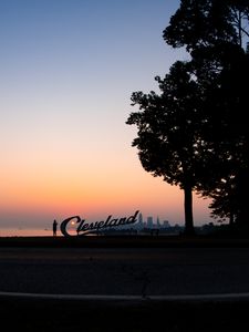 Preview wallpaper silhouettes, tree, sunset, sea, city