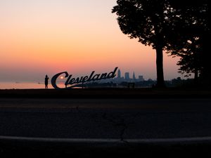 Preview wallpaper silhouettes, tree, sunset, sea, city