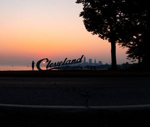 Preview wallpaper silhouettes, tree, sunset, sea, city