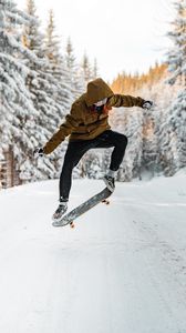 Preview wallpaper skateboarder, skateboard, jump, trick, snow, winter