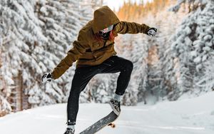 Preview wallpaper skateboarder, skateboard, jump, trick, snow, winter