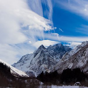 Preview wallpaper sky, blue, clouds, lungs, mountains, greatness, snow-covered, tops, contrast