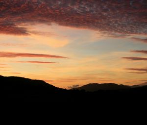 Preview wallpaper sky, clouds, sunset, hills, dark