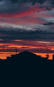 Preview wallpaper sky, sunset, building, cloudy, clouds