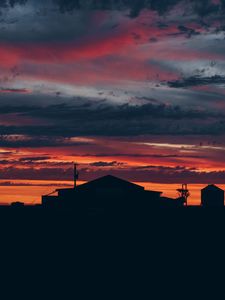 Preview wallpaper sky, sunset, building, cloudy, clouds