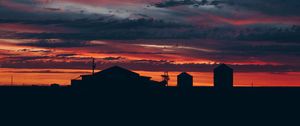 Preview wallpaper sky, sunset, building, cloudy, clouds