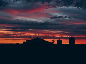 Preview wallpaper sky, sunset, building, cloudy, clouds