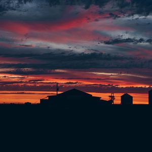 Preview wallpaper sky, sunset, building, cloudy, clouds