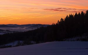 Preview wallpaper sky, trees, dawn, snow, clouds