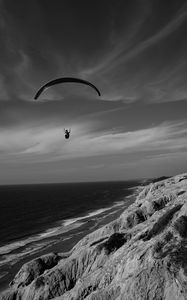 Preview wallpaper skydiver, ocean, coast, black and white