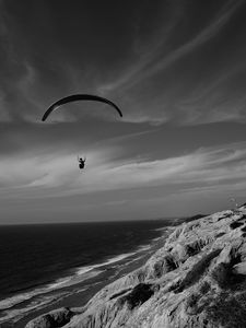 Preview wallpaper skydiver, ocean, coast, black and white