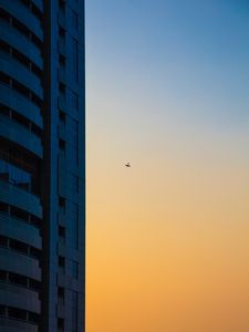 Preview wallpaper skyscraper, airplane, dawn, minimalism