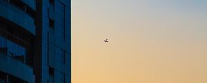 Preview wallpaper skyscraper, airplane, dawn, minimalism