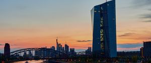 Preview wallpaper skyscraper, building, lights, bridge, river, twilight