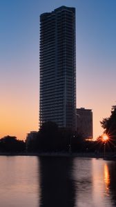 Preview wallpaper skyscraper, building, pond, sunset, city