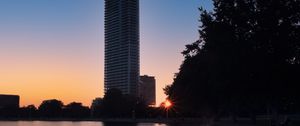 Preview wallpaper skyscraper, building, pond, sunset, city