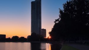 Preview wallpaper skyscraper, building, pond, sunset, city