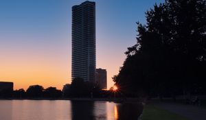 Preview wallpaper skyscraper, building, pond, sunset, city