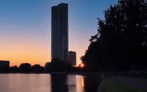 Preview wallpaper skyscraper, building, pond, sunset, city