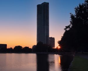 Preview wallpaper skyscraper, building, pond, sunset, city