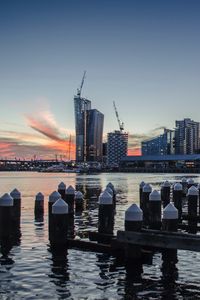 Preview wallpaper skyscraper, buildings, city, water, dusk