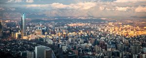 Preview wallpaper skyscraper, buildings, city, architecture, mountains, clouds