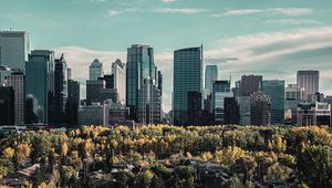 Preview wallpaper skyscraper, buildings, mountains, forest