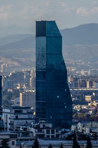 Preview wallpaper skyscraper, buildings, mountains, city