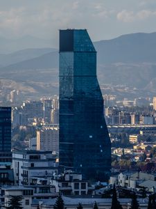 Preview wallpaper skyscraper, buildings, mountains, city