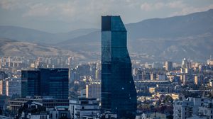 Preview wallpaper skyscraper, buildings, mountains, city