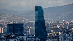 Preview wallpaper skyscraper, buildings, mountains, city