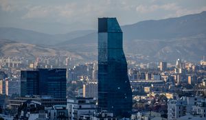 Preview wallpaper skyscraper, buildings, mountains, city