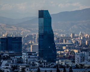 Preview wallpaper skyscraper, buildings, mountains, city