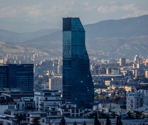 Preview wallpaper skyscraper, buildings, mountains, city