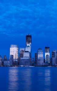 Preview wallpaper skyscraper, buildings, river, lights, evening, blue