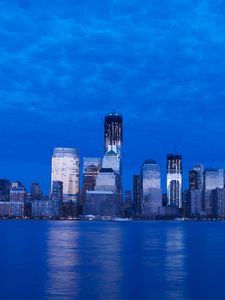 Preview wallpaper skyscraper, buildings, river, lights, evening, blue