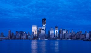 Preview wallpaper skyscraper, buildings, river, lights, evening, blue