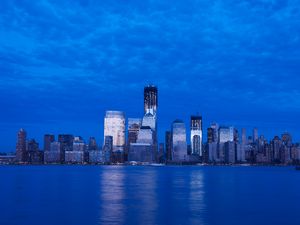 Preview wallpaper skyscraper, buildings, river, lights, evening, blue