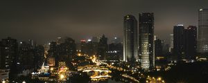 Preview wallpaper skyscraper, buildings, road, lights, city, night