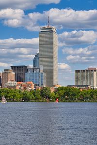 Preview wallpaper skyscraper, buildings, trees, river, city