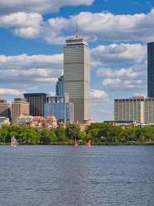 Preview wallpaper skyscraper, buildings, trees, river, city