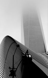 Preview wallpaper skyscraper, fog, roof, spotlight, black and white