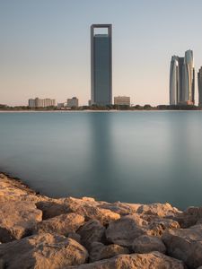 Preview wallpaper skyscraper, sea, stones, coast, city, abu dhabi, uae