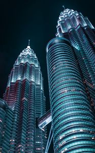 Preview wallpaper skyscrapers, architecture, backlight, view from below, night