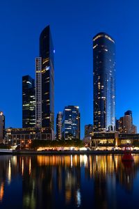 Preview wallpaper skyscrapers, architecture, reflection, lights, night