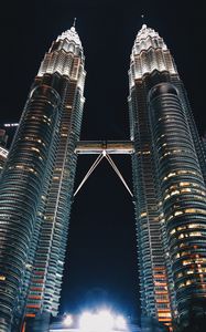 Preview wallpaper skyscrapers, bottom view, towers, architecture, lighting, metropolis