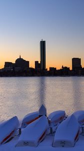 Preview wallpaper skyscrapers, buildings, boats, water, sunset