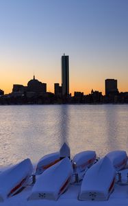 Preview wallpaper skyscrapers, buildings, boats, water, sunset