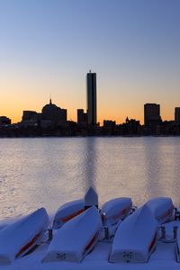 Preview wallpaper skyscrapers, buildings, boats, water, sunset